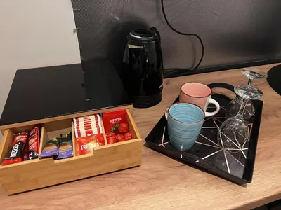 a wooden box sitting on a table next to a coffee maker at Apartman ROYAL Bulevar in Zenica