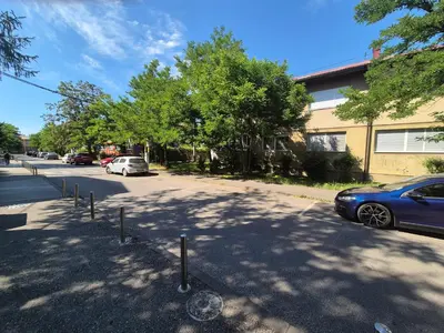 a street with cars parked next to a building at E&A Apartman Ajla i Amir in Tuzla