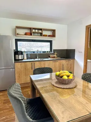 a kitchen with a table with a bowl of bananas on it at Aqua Vita Concept in Bihać
