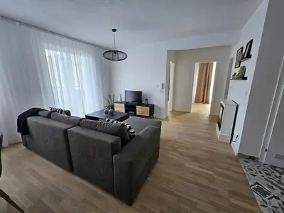 a living room with a couch and a table at Apartman 33 in Kiseljak