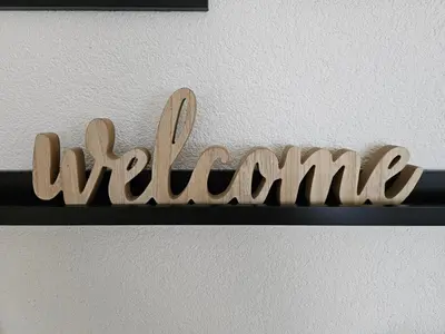 a wooden sign that sayswinding on a shelf at Apartman 33 in Kiseljak