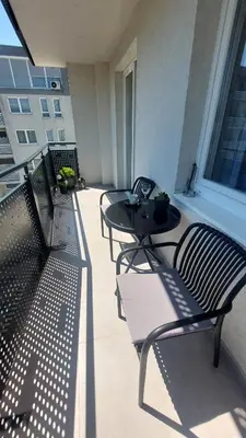 a patio with three chairs and a table on a balcony at Apartman 33 in Kiseljak