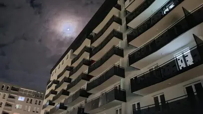 a building with balconies on the side at night at Apartman 33 in Kiseljak