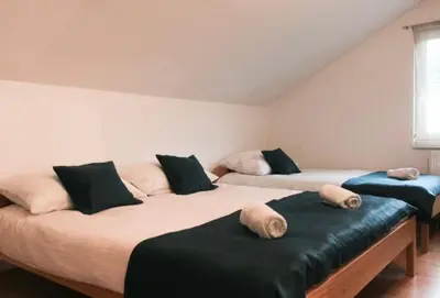 two beds with pillows on them in a room at Apartman Oskar 1 in Kupres
