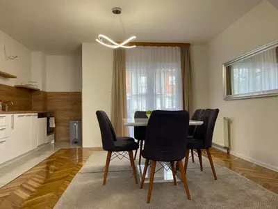 a kitchen and dining room with a table and chairs at BORIĆI in Bihać