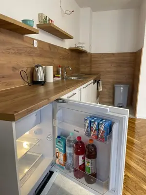 an open refrigerator with drinks in it in a kitchen at BORIĆI in Bihać