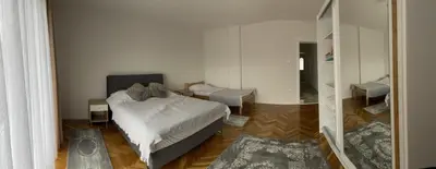 a bedroom with a white bed and a mirror at BORIĆI in Bihać