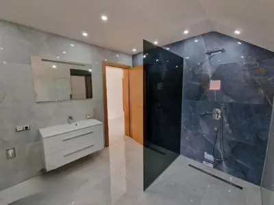 a large bathroom with a shower and a sink at BORIĆI in Bihać
