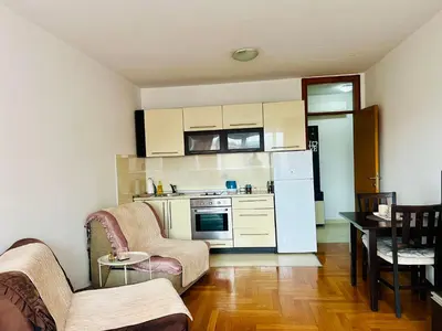 a kitchen with a couch and chairs in a room at Apartman A&A in Banja Luka