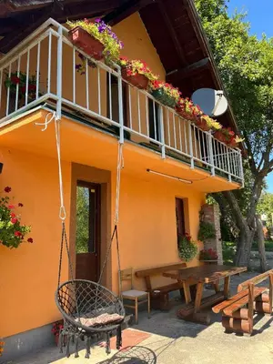 a house with a picnic table and a balcony at Bed and Breakfast Family Djukic in Šipovo