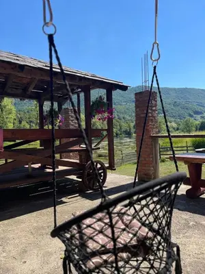 a swing in front of a picnic table at Bed and Breakfast Family Djukic in Šipovo