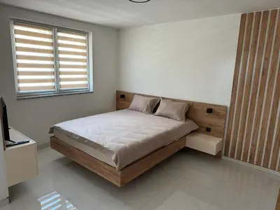 a bedroom with a bed and a window at Apartmani Marković in Doboj
