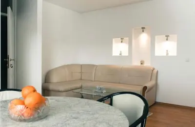 a living room with a couch and a table at Apartman Oskar 2 in Kupres