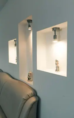 a room with a couch and two mirrors on the wall at Apartman Oskar 2 in Kupres