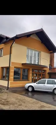 a silver car parked in front of a house at SOBE CICKO in Bosansko Petrovo Selo