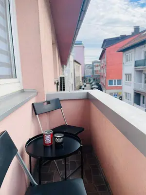 a small table and two chairs on a balcony at Apartment Zara Bihac in Bihać