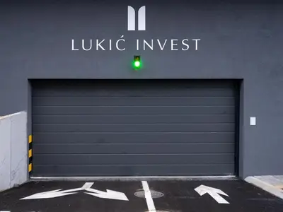a garage door with a green light in front of a building at Apartman K&S in Banja Luka