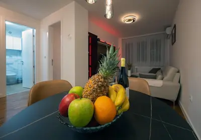 a bowl of fruit on a table in a living room at Apartman K&S in Banja Luka
