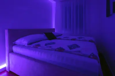 a bedroom with a bed in a purple room at Apartman K&S in Banja Luka