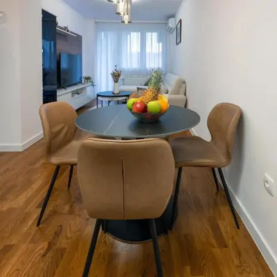 a dining room table with a bowl of fruit on it at Apartman K&S in Banja Luka