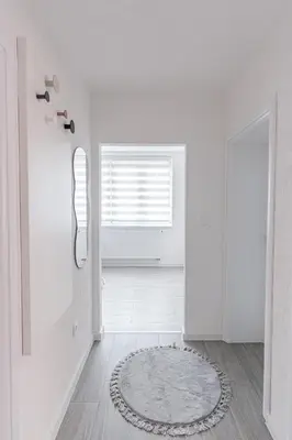 a white room with a window and a rug on the floor at Mona Visoko in Visoko