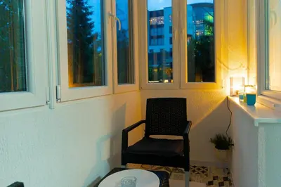 a chair sitting in a room with windows at Mona Visoko in Visoko