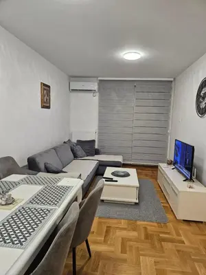 a living room with a couch and a table at Apartment Zidart Banja Luka free garage in Banja Luka