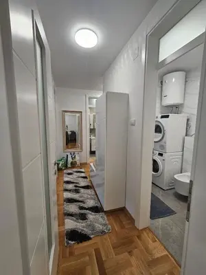 a room with a hallway with a sink and a washing machine at Apartment Zidart Banja Luka free garage in Banja Luka