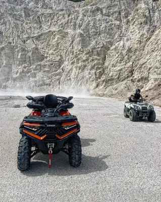 two atvs and a man sitting on the road at Vikendica u prirodi na ranču in Zolaći