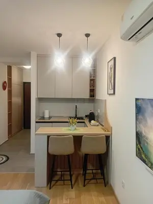 a kitchen with a counter and two bar stools at Apartman 33 in Banja Luka