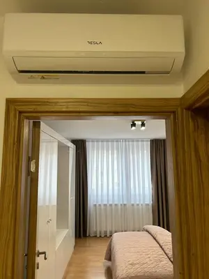 a bedroom with a bed and a ceiling with a window at Apartman Mona in Teslić