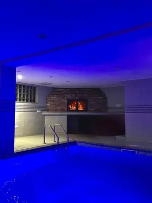 a swimming pool with a fireplace in a house at Villa SHAMS in Travnik