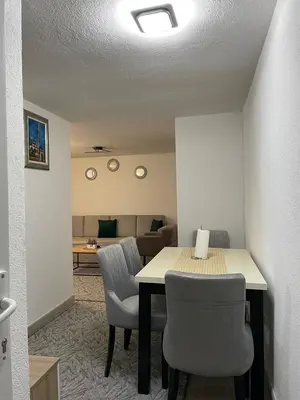 a room with a table and chairs and a living room at Villa SHAMS in Travnik