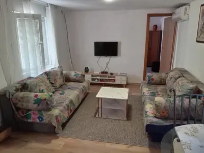 a living room with two couches and a tv at Apartman Babli in Banja Luka