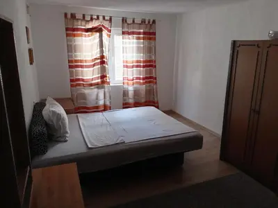 a room with a bed in front of a window at Apartman Babli in Banja Luka
