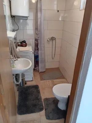 a small bathroom with a sink and a toilet at Apartman Babli in Banja Luka