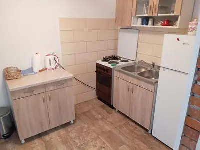 a small kitchen with a sink and a refrigerator at Apartman Babli in Banja Luka