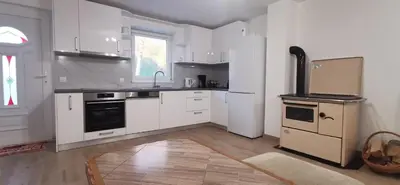 a kitchen with white cabinets and a stove top oven at Fortuna in Livno