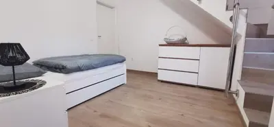 a bedroom with a bed and a staircase at Fortuna in Livno