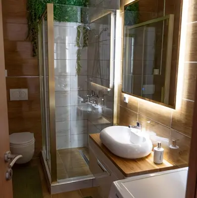 a bathroom with a sink and a shower at ZARA Apartman Živinice in Živinice