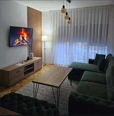 a living room with a couch and a coffee table at ZARA Apartman Živinice in Živinice