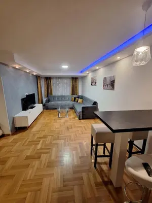 a living room with a couch and a table at Luks 3 apartment in Banja Luka