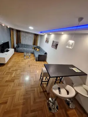 a living room with a table and a couch at Luks 3 apartment in Banja Luka