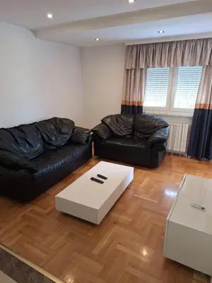 a living room with two leather couches and a box at Luks 3 apartment in Banja Luka