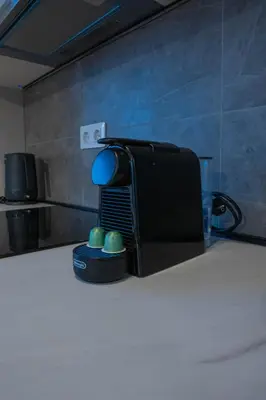 a black toaster sitting on top of a counter at Apartment ALPHA in Banja Luka