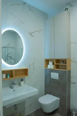 a bathroom with a sink and a toilet and a mirror at Apartment ALPHA in Banja Luka