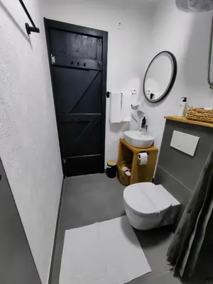 a bathroom with a toilet and a sink and a mirror at Garden Relax Bungalow 