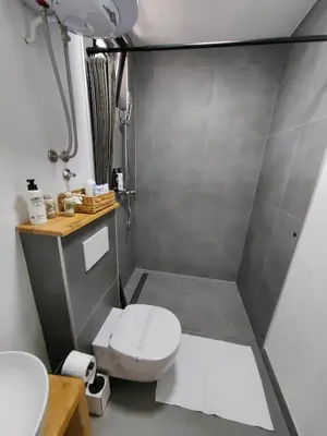 a bathroom with a toilet and a sink at Garden Relax Bungalow 