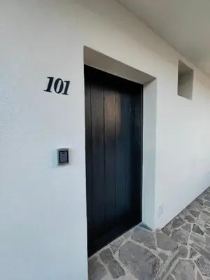 a black door on the side of a building at Garden Relax Bungalow 
