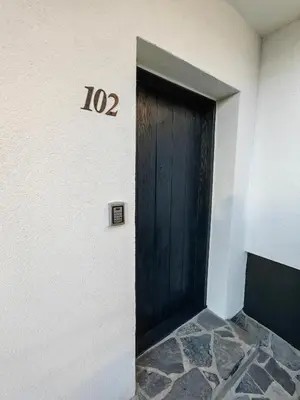a door with the number on the side of a building at Garden Relax Bungalow 